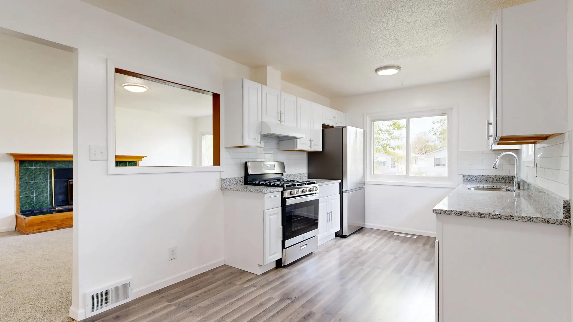 Bright, spotless white kitchen with clean counters and cabinets